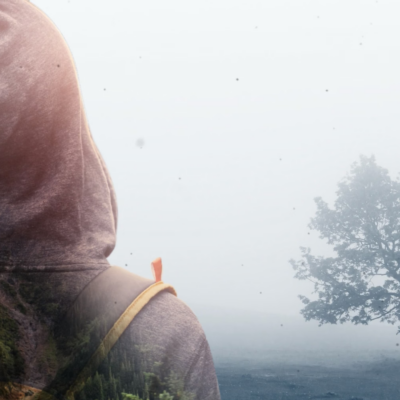 Person standing in front of a tree