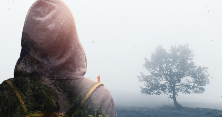 Person standing in front of a tree
